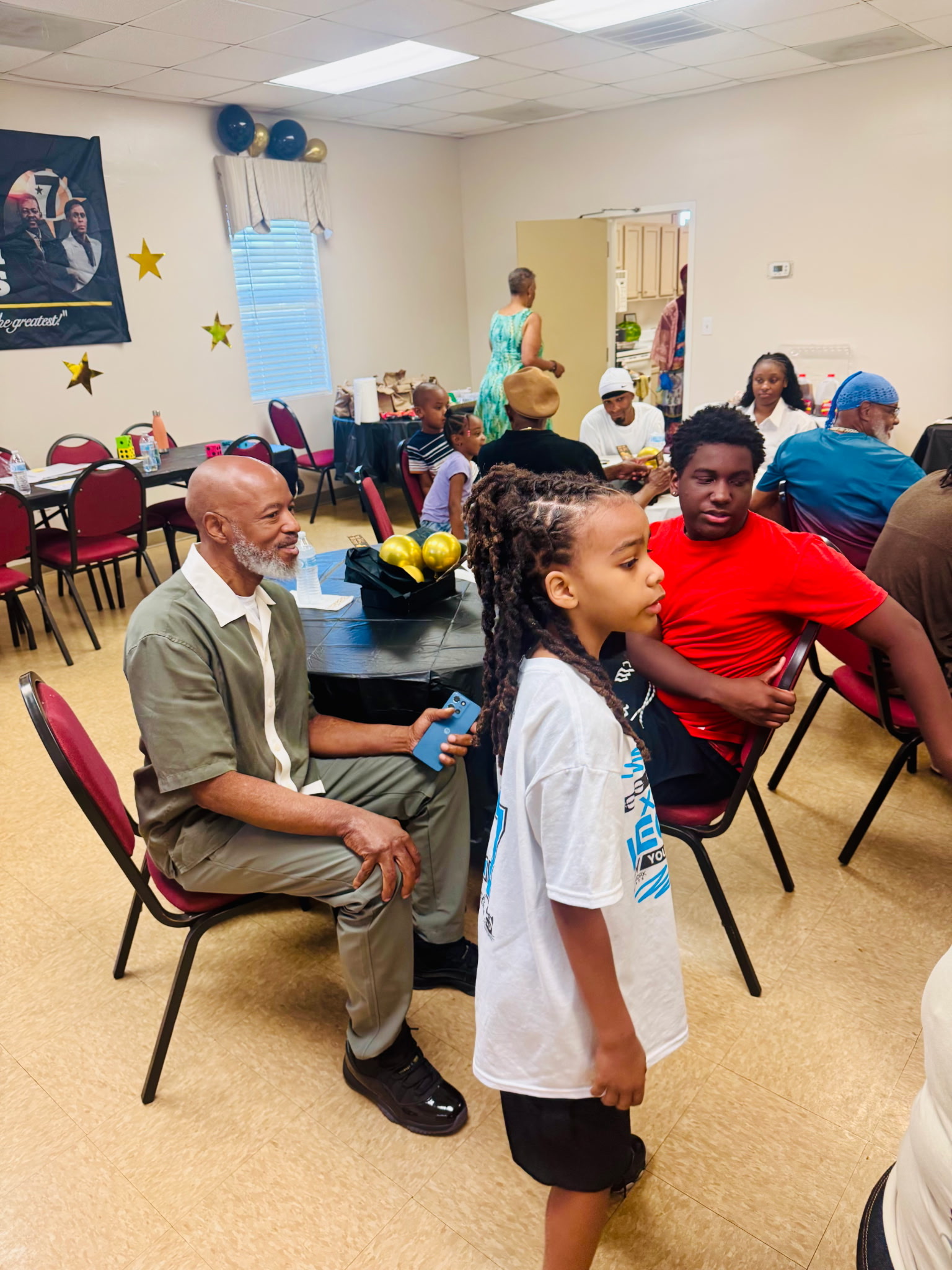 Ronnie speaking with children and community members